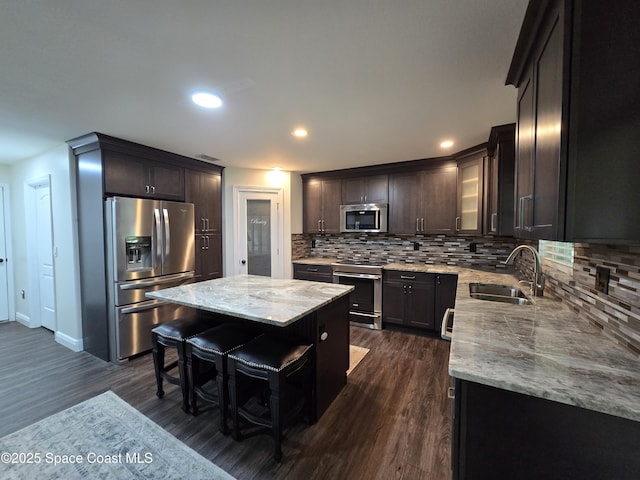 334 Dryden Cir, Cocoa, FL 32926 - kitchen with stainless steel appliances, a sink, light stone countertops, backsplash, and recessed lighting
