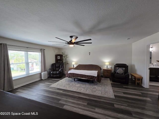 334 Dryden Cir, Cocoa, FL 32926 - bedroom with wood finished floors, a textured ceiling, baseboards, ceiling fan, and connected bathroom