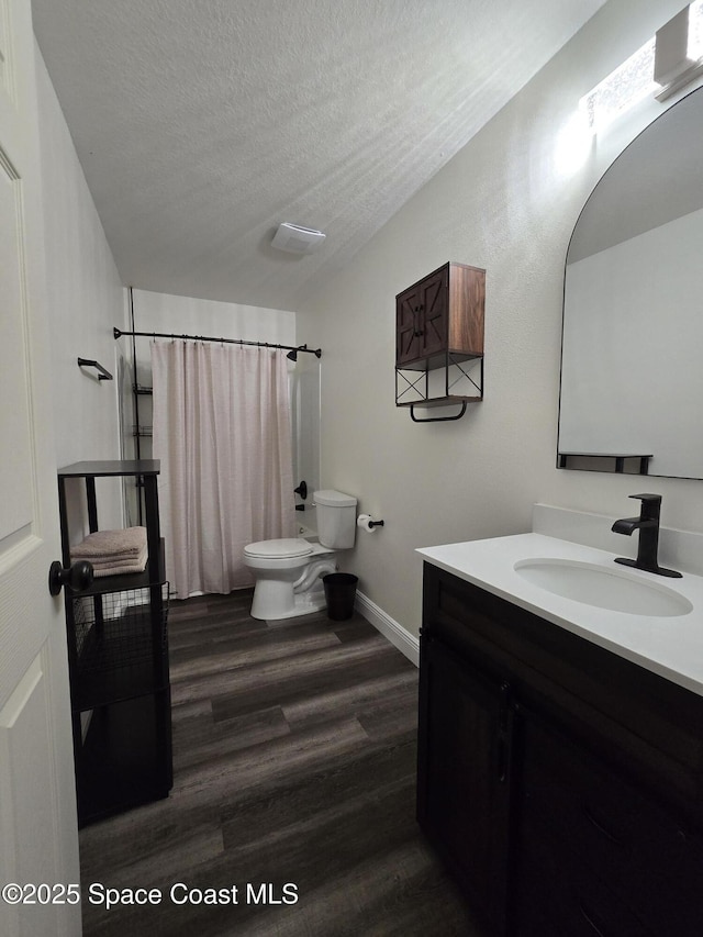 334 Dryden Cir, Cocoa, FL 32926 - full bathroom featuring lofted ceiling, toilet, wood finished floors, vanity, and baseboards