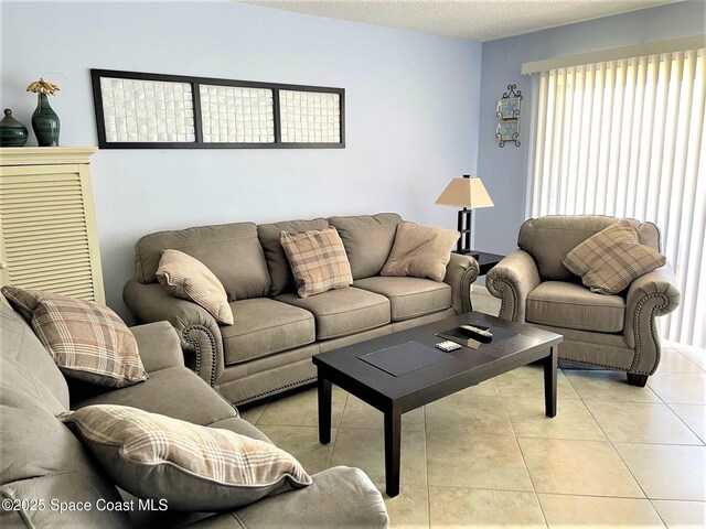 35 Sunflower St Unit 59, Cocoa Beach, FL 32931 - living room featuring light tile patterned floors and a textured ceiling