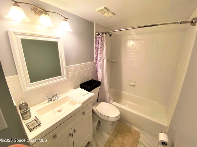 35 Sunflower St Unit 59, Cocoa Beach, FL 32931 - bathroom with tile walls, toilet, shower / bath combination with curtain, vanity, and wainscoting