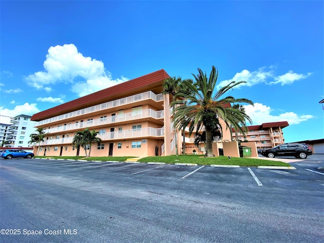 35 Sunflower St Unit 59, Cocoa Beach, FL 32931 - view of apartment building / complex with uncovered parking