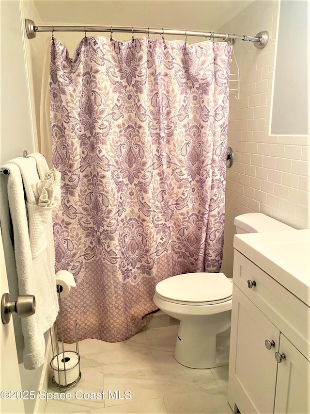 35 Sunflower St Unit 59, Cocoa Beach, FL 32931 - full bathroom with toilet, a shower with curtain, tile walls, and vanity