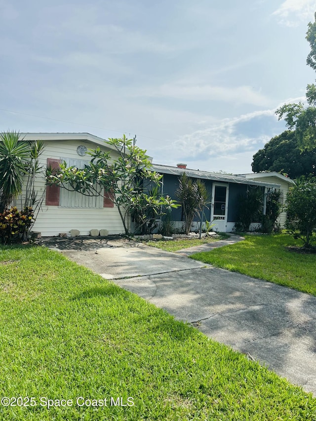 2174 Woodbury Rd, Melbourne, FL 32935 - view of front of house with a front lawn