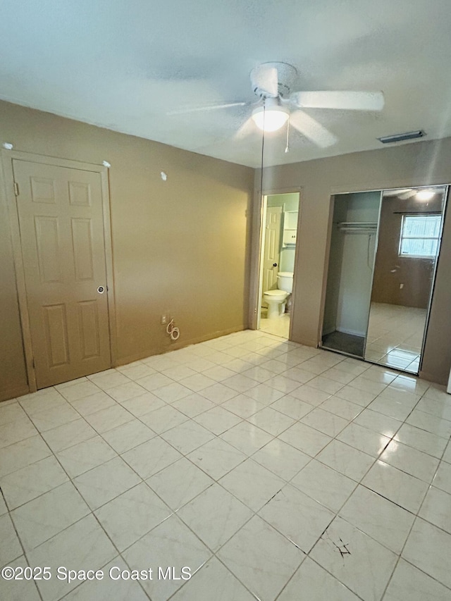 2174 Woodbury Rd, Melbourne, FL 32935 - unfurnished bedroom with a closet, light tile patterned floors, and ceiling fan