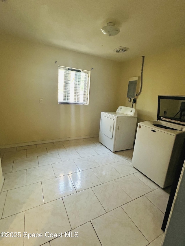 2174 Woodbury Rd, Melbourne, FL 32935 - laundry area with separate washer and dryer and light tile patterned floors