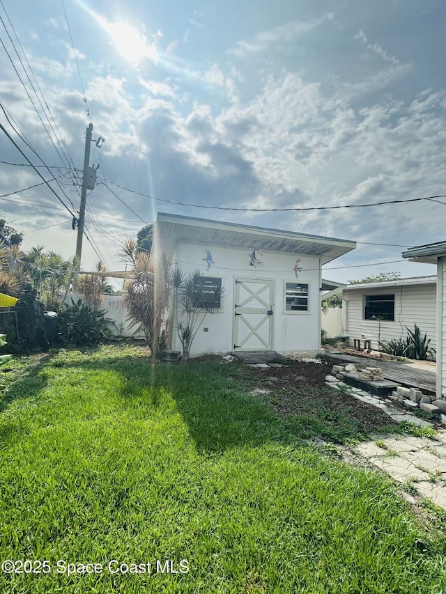 2174 Woodbury Rd, Melbourne, FL 32935 - rear view of house with an outbuilding
