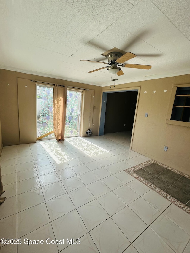 2174 Woodbury Rd, Melbourne, FL 32935 - empty room with ceiling fan and light tile patterned floors