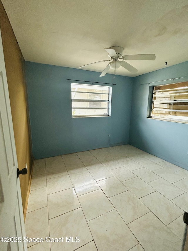 2174 Woodbury Rd, Melbourne, FL 32935 - empty room featuring ceiling fan and tile patterned floors