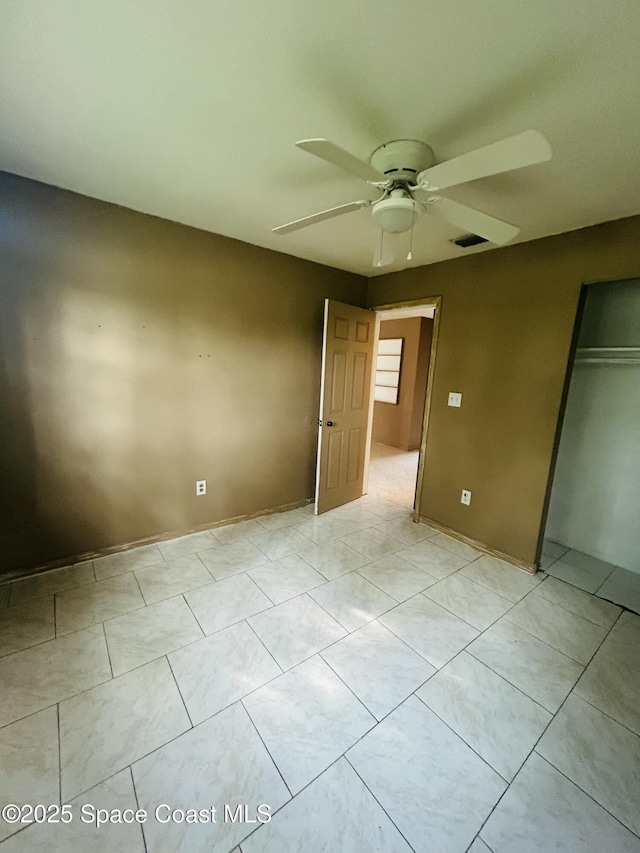 2174 Woodbury Rd, Melbourne, FL 32935 - unfurnished bedroom featuring a closet, light tile patterned flooring, and ceiling fan