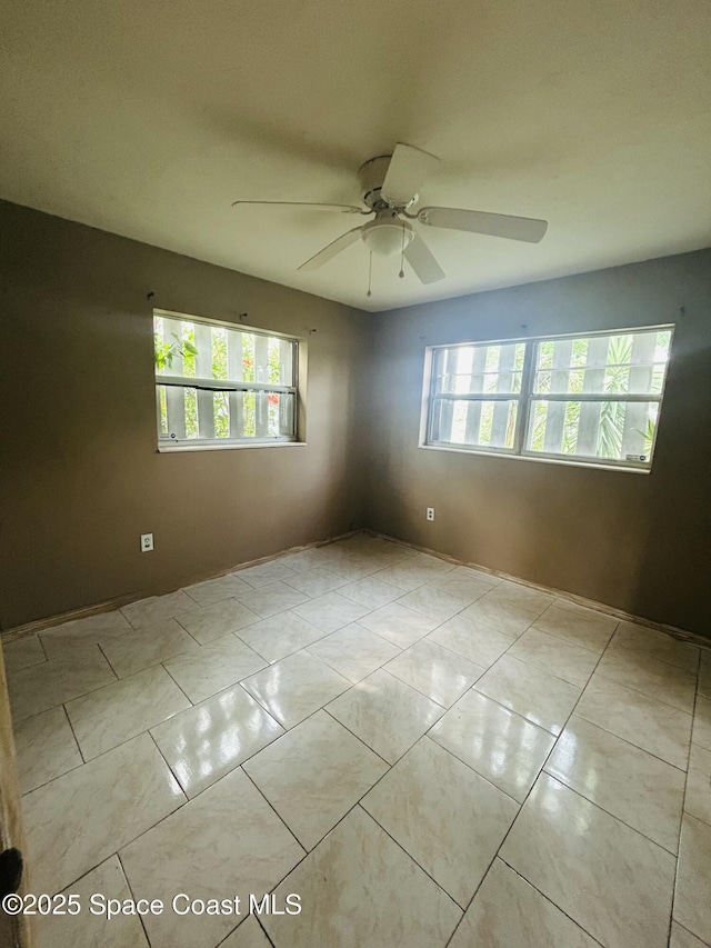 2174 Woodbury Rd, Melbourne, FL 32935 - tiled spare room featuring a ceiling fan