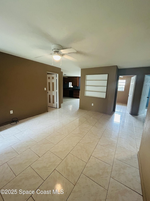 2174 Woodbury Rd, Melbourne, FL 32935 - empty room with light tile patterned floors and ceiling fan
