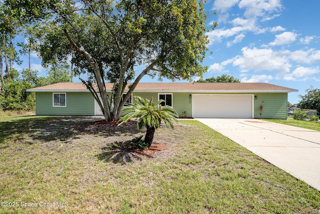 645 Ontario St NW, Palm Bay, FL 32907 - single story home featuring a garage, concrete driveway, and a front lawn