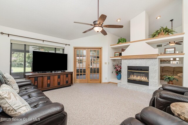 7793 Windover Way, Titusville, FL 32780 - living area with a ceiling fan, lofted ceiling, french doors, a high end fireplace, and carpet floors