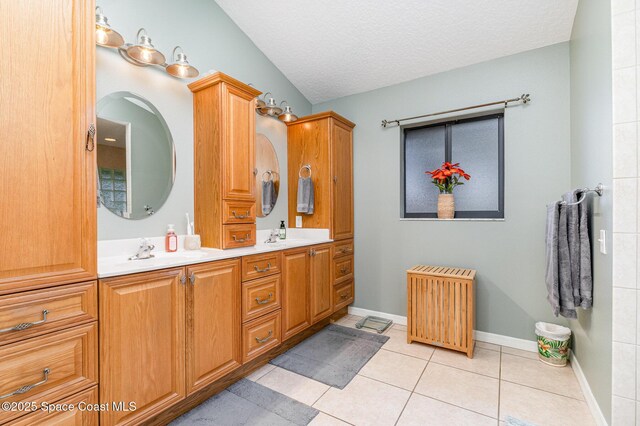 7793 Windover Way, Titusville, FL 32780 - bathroom featuring double vanity, radiator heating unit, tile patterned floors, a textured ceiling, and baseboards