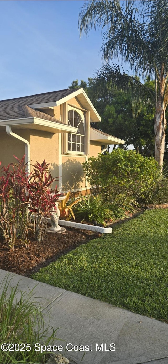 view of side of home featuring stucco siding