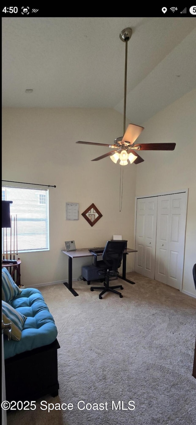home office with carpet flooring, a ceiling fan, baseboards, and high vaulted ceiling