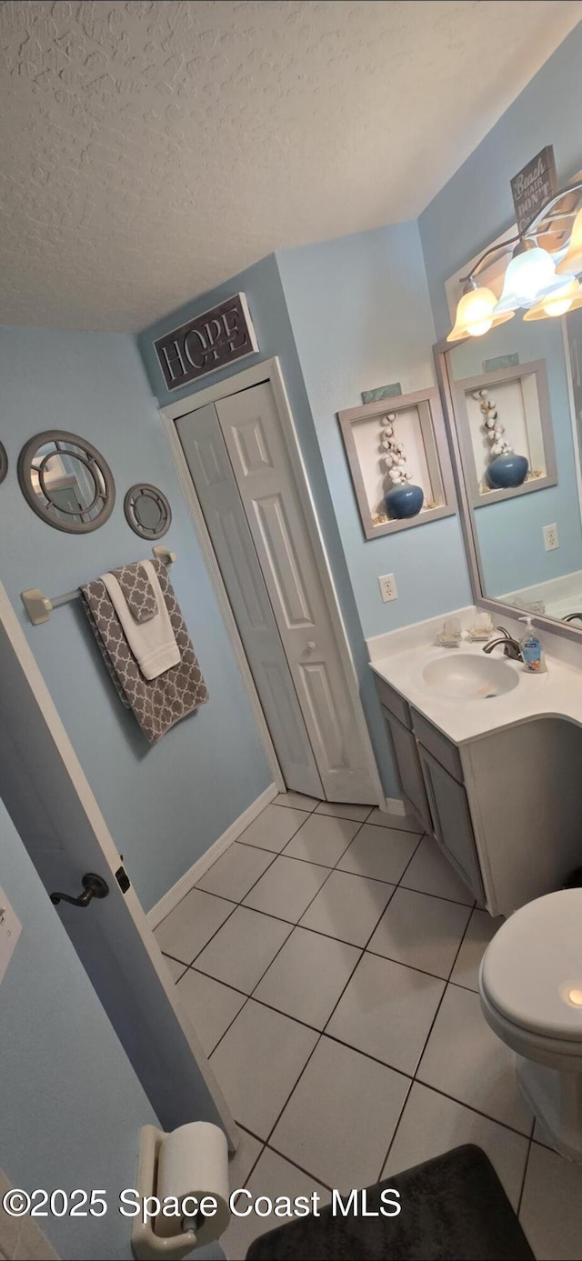 bathroom featuring tile patterned floors, vanity, and a textured ceiling