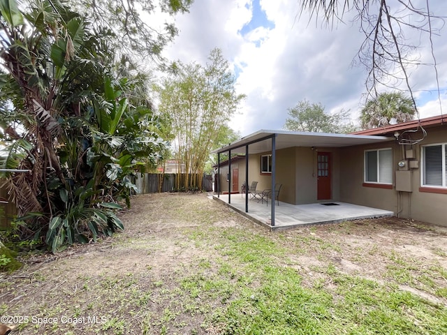 141 Valencia Rd, Rockledge, FL 32955 - fenced backyard with a patio
