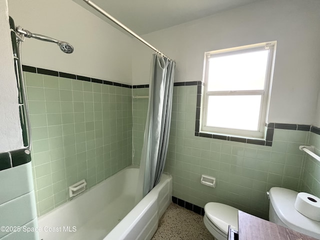 141 Valencia Rd, Rockledge, FL 32955 - full bath featuring toilet, speckled floor, shower / bath combo, and tile walls