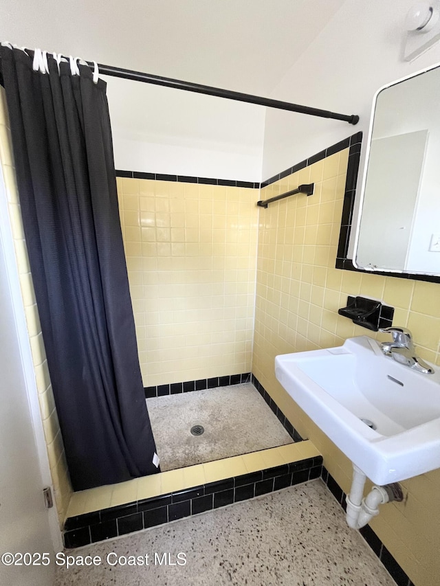 141 Valencia Rd, Rockledge, FL 32955 - full bathroom with speckled floor, a stall shower, and tile walls