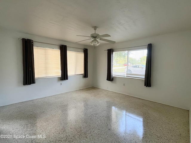 141 Valencia Rd, Rockledge, FL 32955 - empty room with speckled floor and ceiling fan
