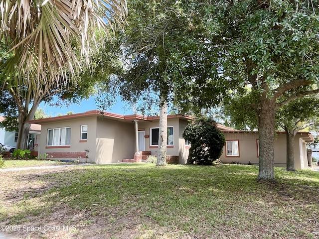 141 Valencia Rd, Rockledge, FL 32955 - view of front of property featuring stucco siding and a front lawn