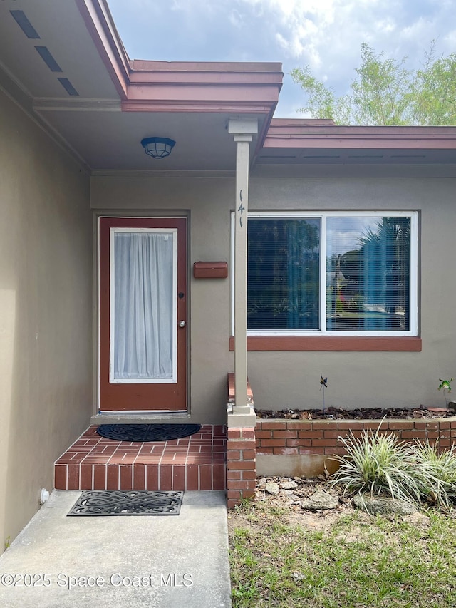 141 Valencia Rd, Rockledge, FL 32955 - property entrance with stucco siding