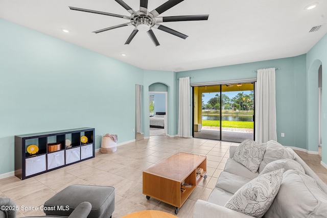 3575 Salt Marsh Cir, West Melbourne, FL 32904 - living area featuring arched walkways, a water view, ceiling fan, baseboards, and recessed lighting
