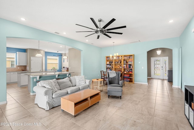 3575 Salt Marsh Cir, West Melbourne, FL 32904 - living room with arched walkways, light tile patterned floors, ceiling fan, and recessed lighting
