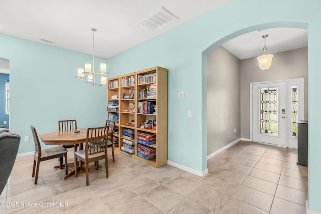 3575 Salt Marsh Cir, West Melbourne, FL 32904 - dining room featuring arched walkways, a chandelier, baseboards, and light tile patterned flooring