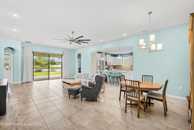 3575 Salt Marsh Cir, West Melbourne, FL 32904 - dining space featuring arched walkways, ceiling fan, recessed lighting, baseboards, and a chandelier