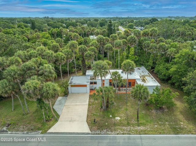 2318 Country Club Rd, Melbourne, FL 32901 - aerial view of property and surrounding area featuring a heavily wooded area