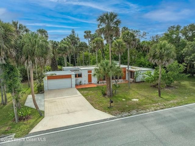 2318 Country Club Rd, Melbourne, FL 32901 - view of front facade featuring a front lawn, driveway, and an attached garage