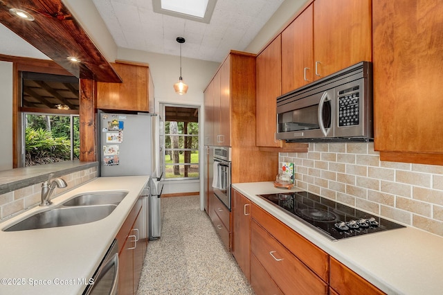 2318 Country Club Rd, Melbourne, FL 32901 - kitchen featuring appliances with stainless steel finishes, a sink, decorative backsplash, brown cabinets, and light countertops