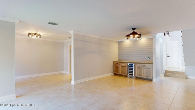 2287 Venetia Pl, Indialantic, FL 32903 - unfurnished living room featuring beverage cooler, ornamental molding, light tile patterned floors, a barn door, and a dry bar