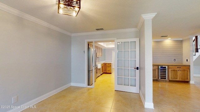 2287 Venetia Pl, Indialantic, FL 32903 - hall featuring wine cooler, light tile patterned flooring, and ornamental molding