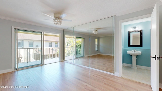 2287 Venetia Pl, Indialantic, FL 32903 - unfurnished bedroom featuring crown molding, multiple windows, access to outside, wood finished floors, and ensuite bathroom
