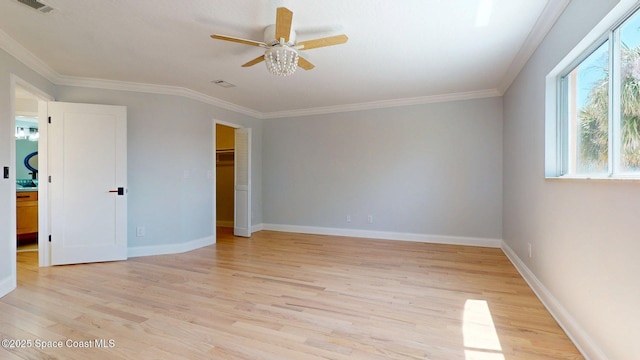 2287 Venetia Pl, Indialantic, FL 32903 - unfurnished bedroom with light wood-type flooring, ornamental molding, a ceiling fan, a walk in closet, and a closet