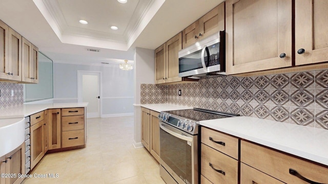 2287 Venetia Pl, Indialantic, FL 32903 - kitchen with appliances with stainless steel finishes, a tray ceiling, recessed lighting, light countertops, and tasteful backsplash