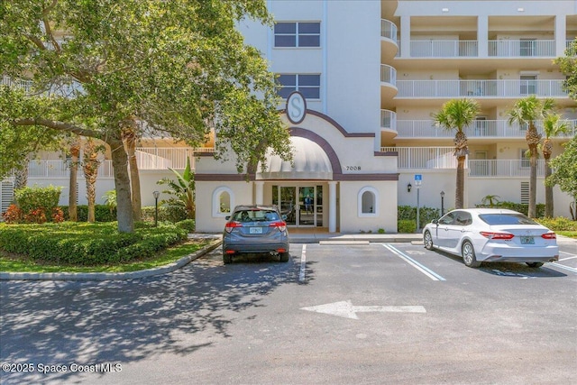 7008 Sevilla Ct Ph 505, Cape Canaveral, FL 32920 - view of apartment building / complex featuring uncovered parking