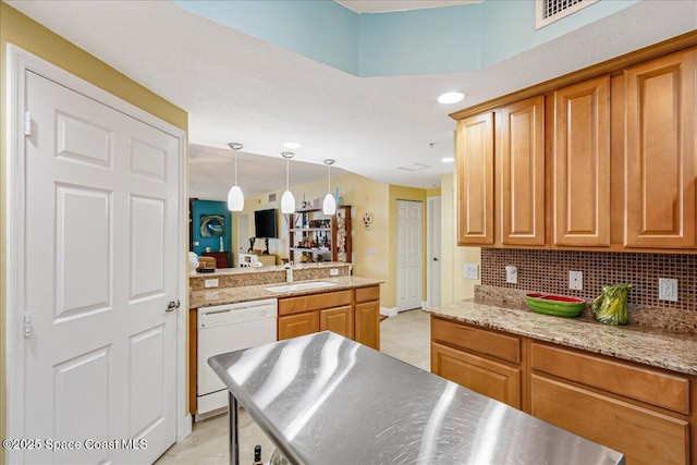 7008 Sevilla Ct Ph 505, Cape Canaveral, FL 32920 - kitchen featuring white dishwasher, a sink, backsplash, decorative light fixtures, and brown cabinetry