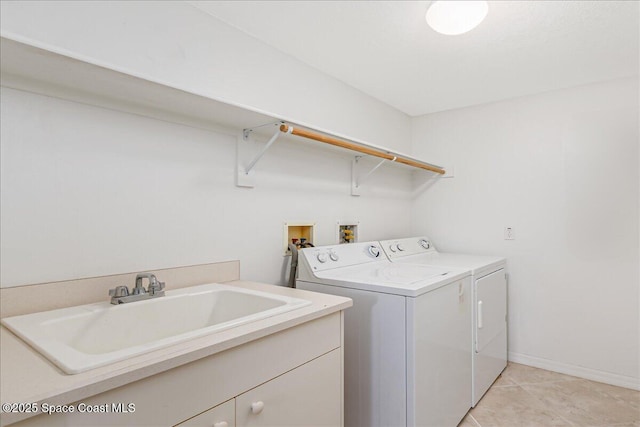 7008 Sevilla Ct Ph 505, Cape Canaveral, FL 32920 - laundry area with cabinet space, washing machine and dryer, light tile patterned flooring, and baseboards