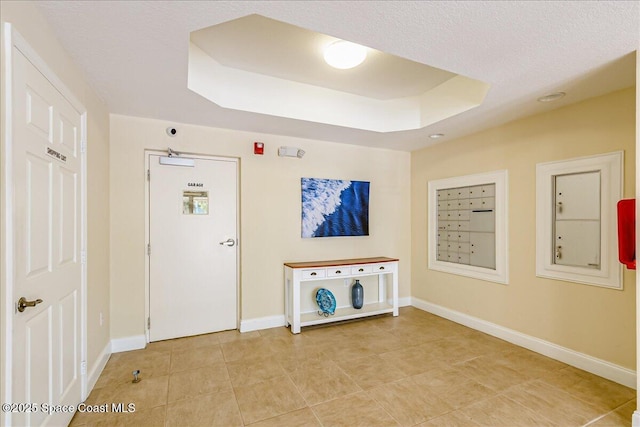 7008 Sevilla Ct Ph 505, Cape Canaveral, FL 32920 - entrance foyer featuring baseboards, a tray ceiling, mail area, and light tile patterned flooring