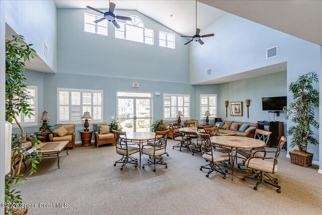 7008 Sevilla Ct Ph 505, Cape Canaveral, FL 32920 - carpeted dining room featuring a ceiling fan, plenty of natural light, and high vaulted ceiling