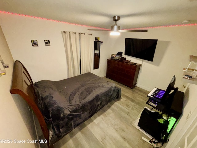 bedroom with wood finished floors and a ceiling fan