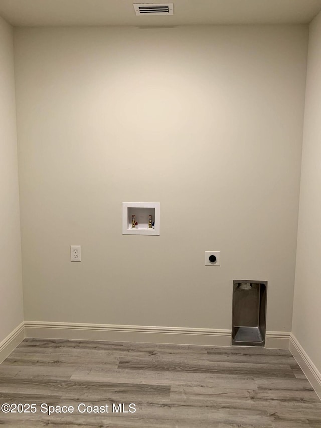 laundry area with wood finished floors, hookup for a washing machine, electric dryer hookup, and baseboards