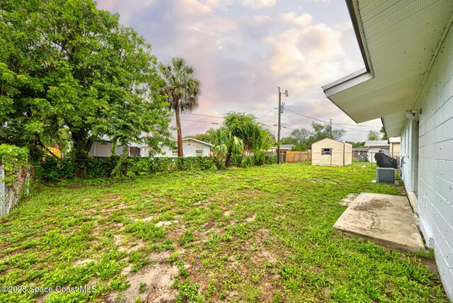 663 Bacon St, Cocoa, FL 32926 - view of yard with a storage unit and an outbuilding