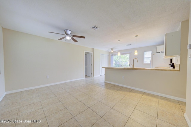 663 Bacon St, Cocoa, FL 32926 - unfurnished room with ceiling fan, baseboards, light tile patterned floors, and a sink