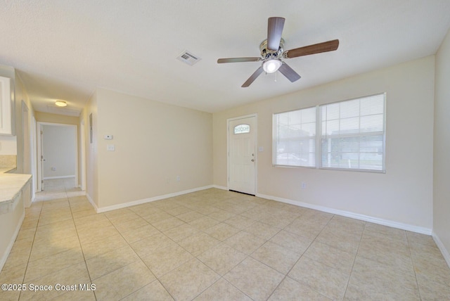 663 Bacon St, Cocoa, FL 32926 - entryway with a ceiling fan, light tile patterned floors, and baseboards